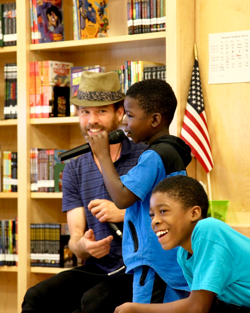 TAI graduate Max Bent beatboxing with students